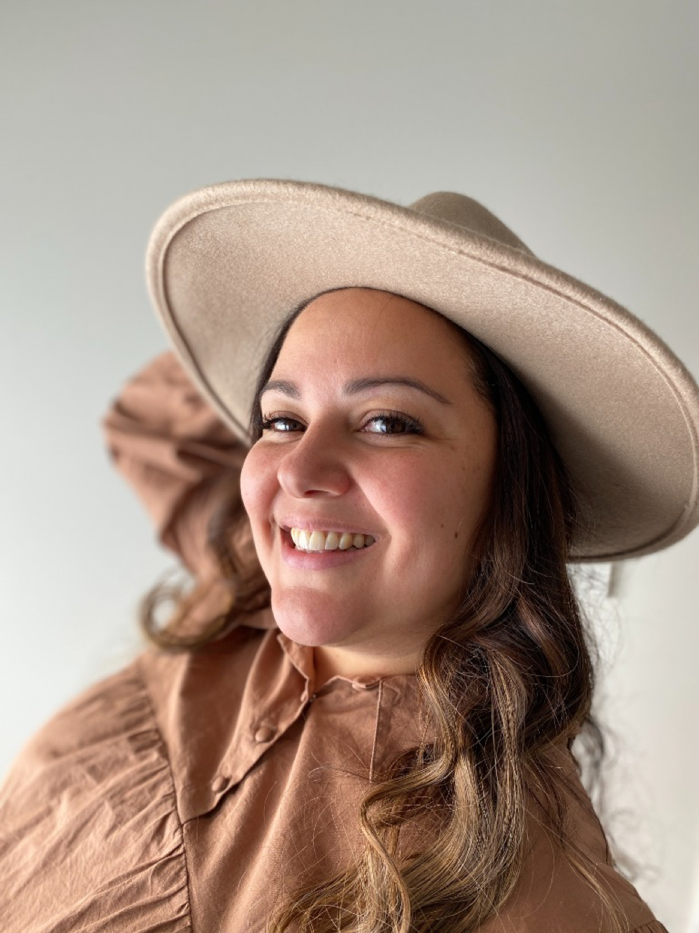 Samoa, founder of Little Archives, smiling warmly in her sunlit studio